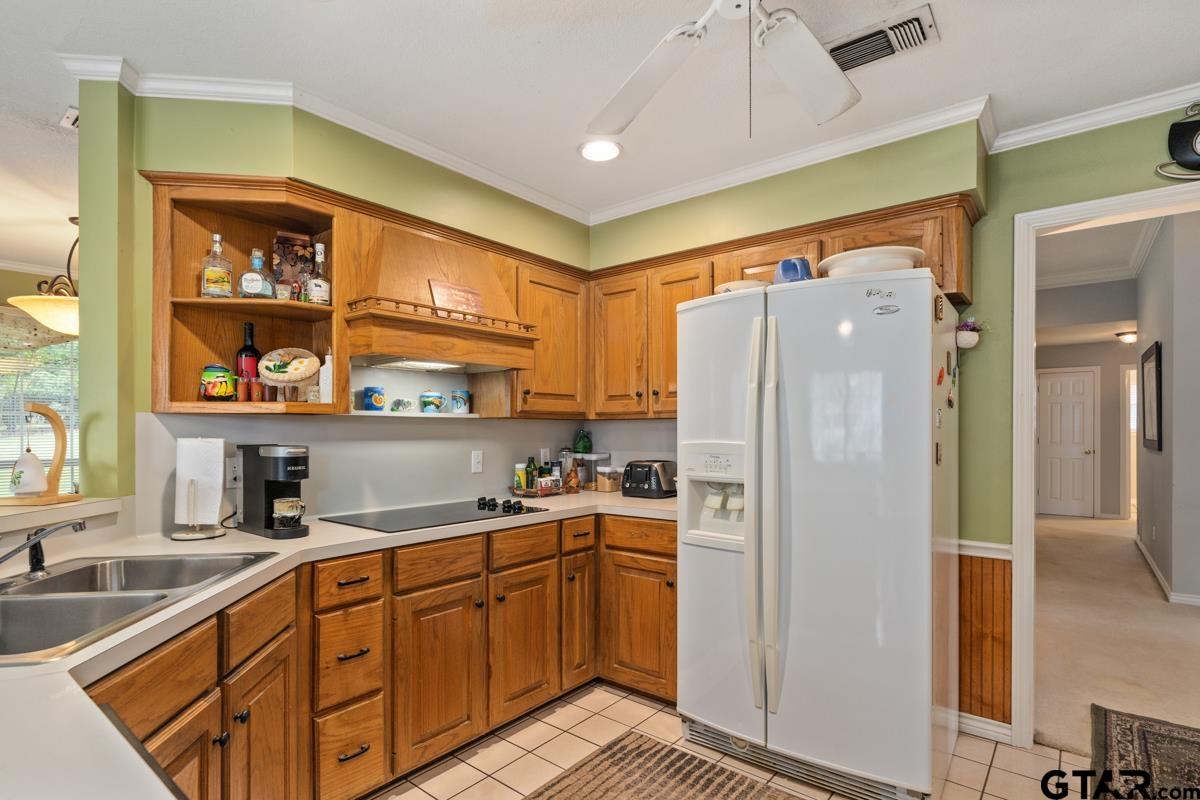 1113 Lonnie Drive Athens, TX 75751 - Photo 17 of 32 a kitchen with a refrigerator and a sink