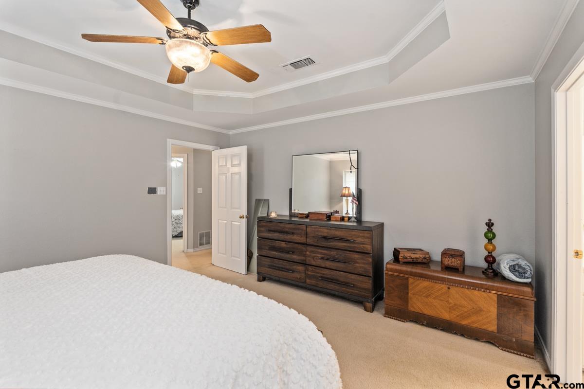 1113 Lonnie Drive Athens, TX 75751 - Photo 20 of 32 a bedroom with a bed and a chandelier