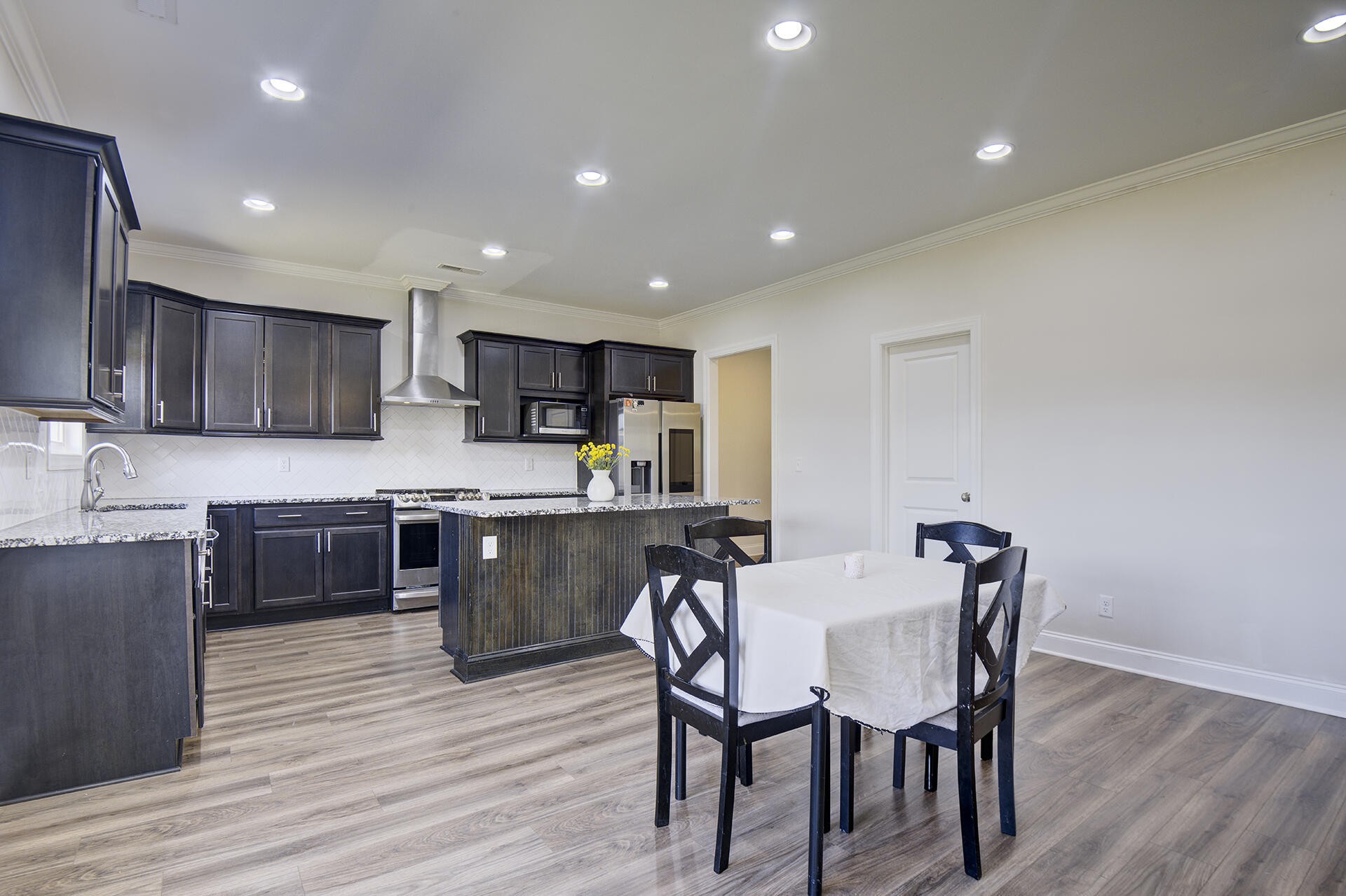 3625 Weathervane Loop Apison, TN 37302 - Photo 11 of 38 a kitchen with stainless steel appliances granite countertop a kitchen island hardwood floor sink and stove
