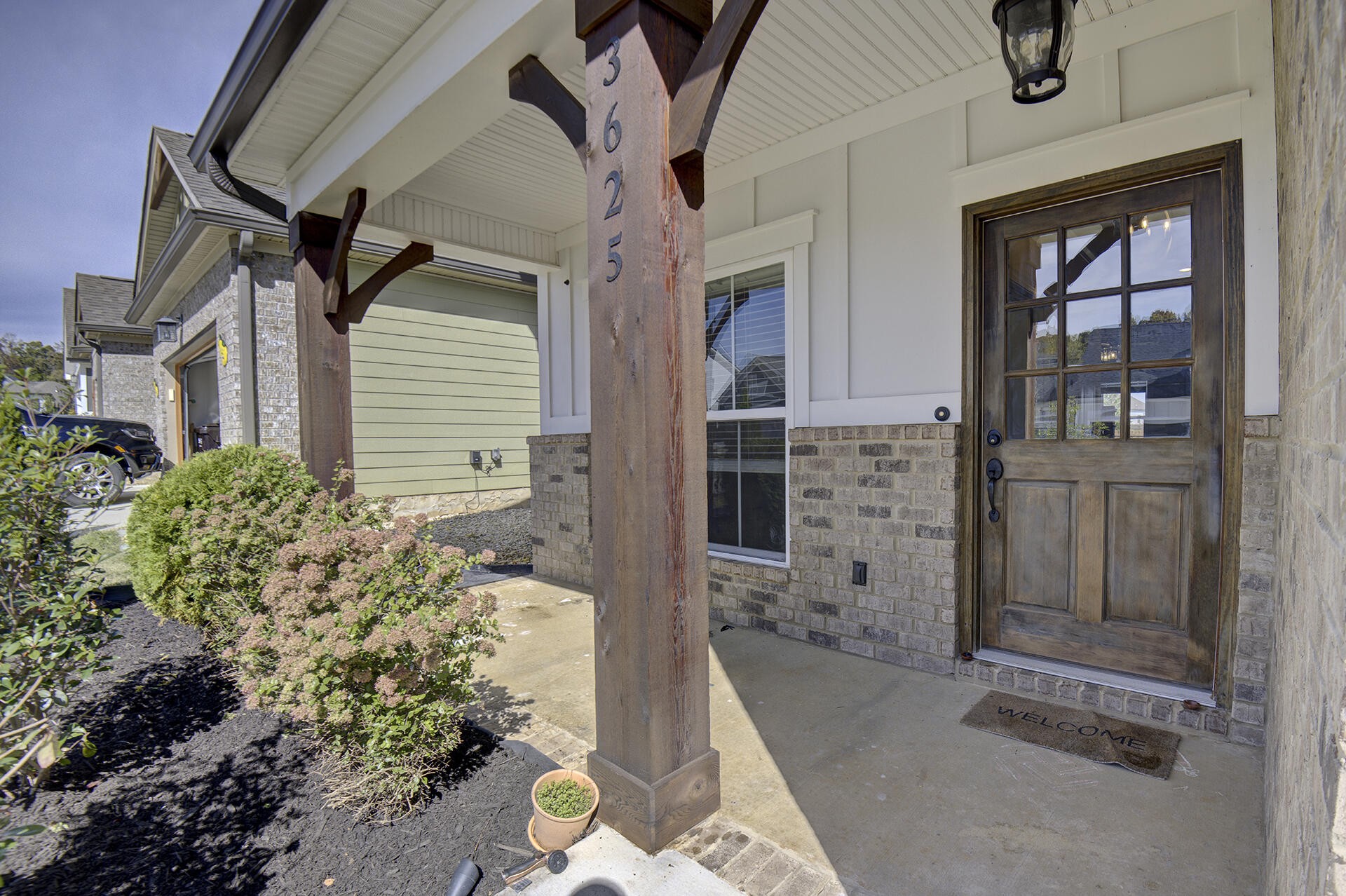 3625 Weathervane Loop Apison, TN 37302 - Photo 2 of 38 front view of a house with a potted plant and floor to ceiling windows