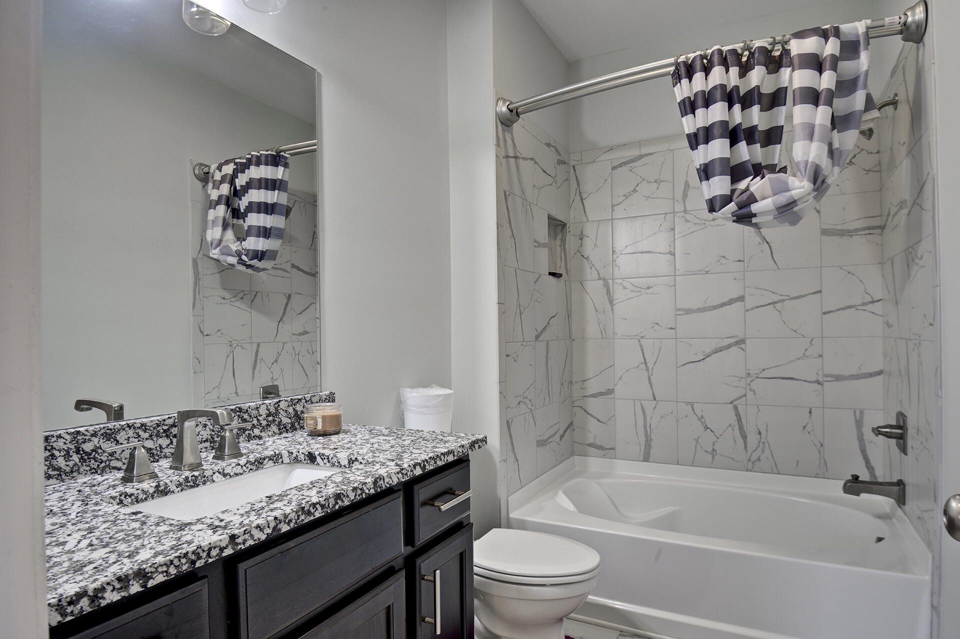3625 Weathervane Loop Apison, TN 37302 - Photo 28 of 38 a bathroom with a granite countertop sink a toilet and bathtub