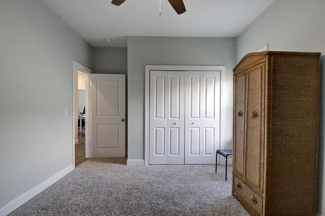an empty room with windows and closet