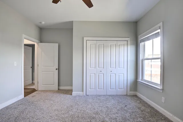 an empty room with windows and closet