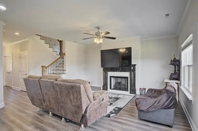 a living room with furniture a flat screen tv and a fireplace