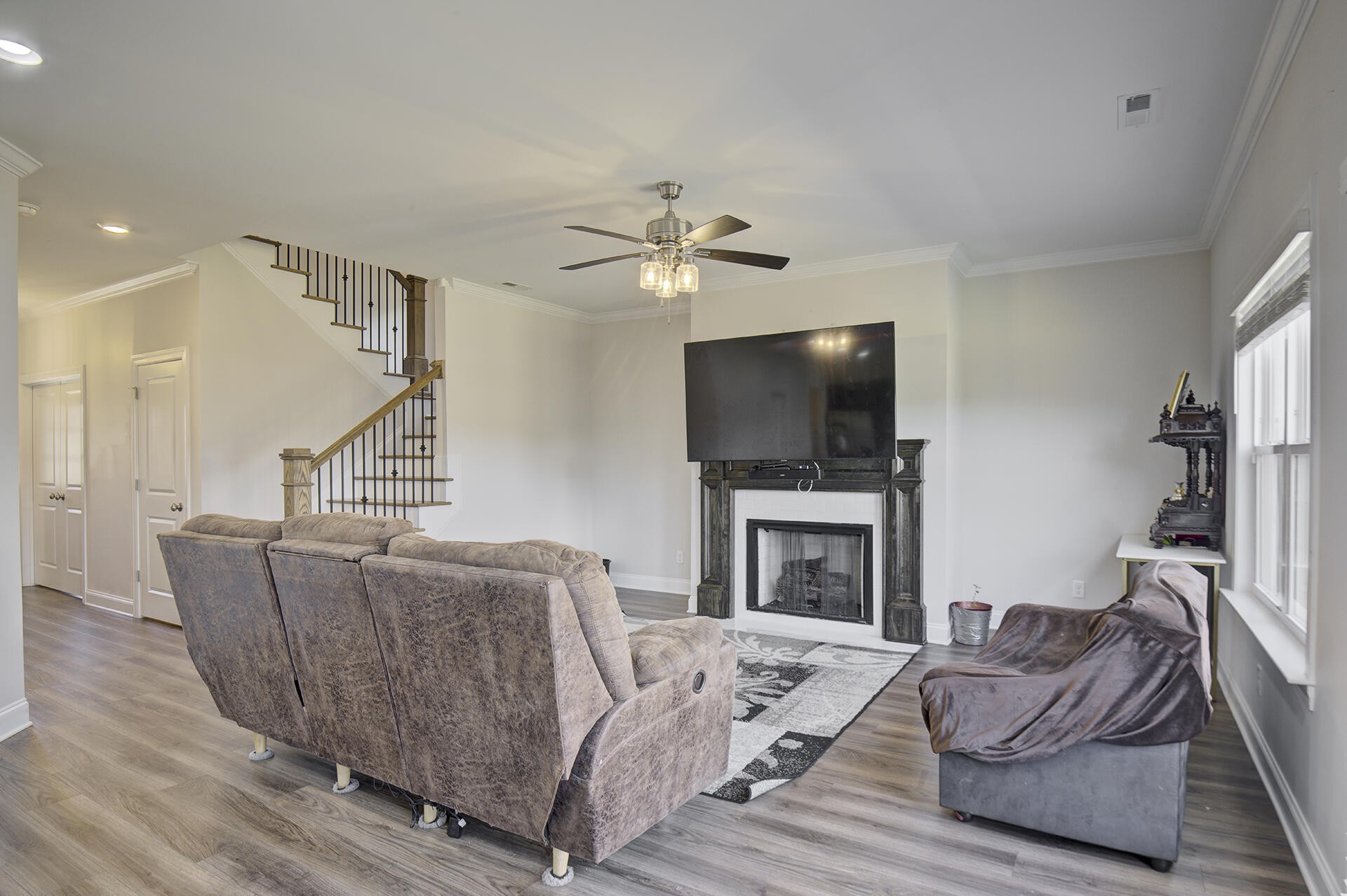 3625 Weathervane Loop Apison, TN 37302 - Photo 7 of 38 a living room with furniture a flat screen tv and a fireplace