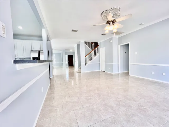 a kitchen with granite countertop a sink a stove and cabinets