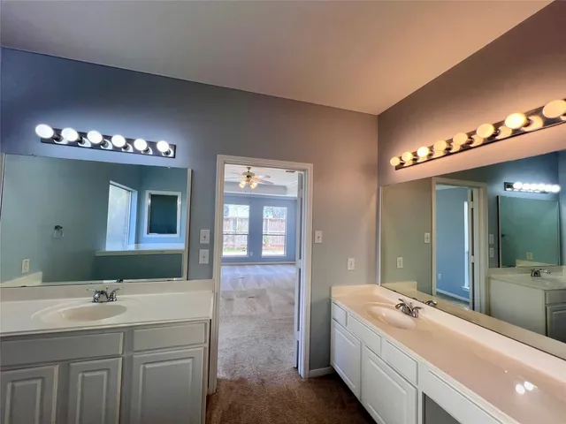 a bathroom with a tub sink and mirror
