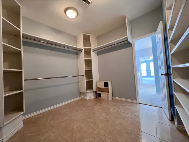 a bathroom with a double vanity sink a large mirror and a shower