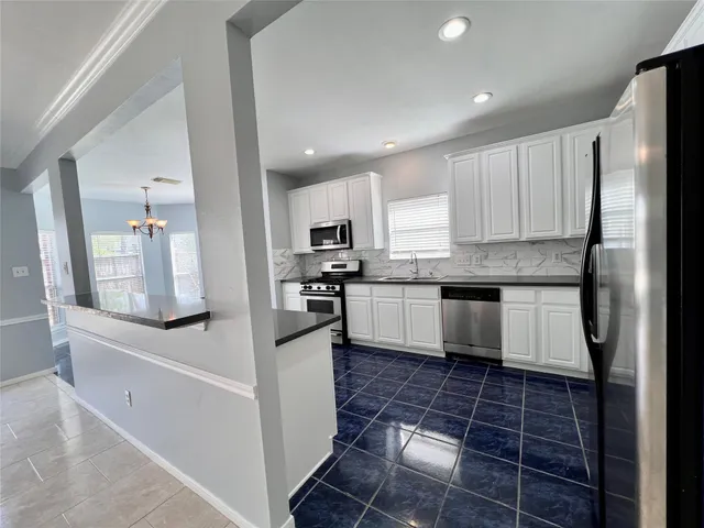 a view of a livingroom with a furniture chandelier and windows