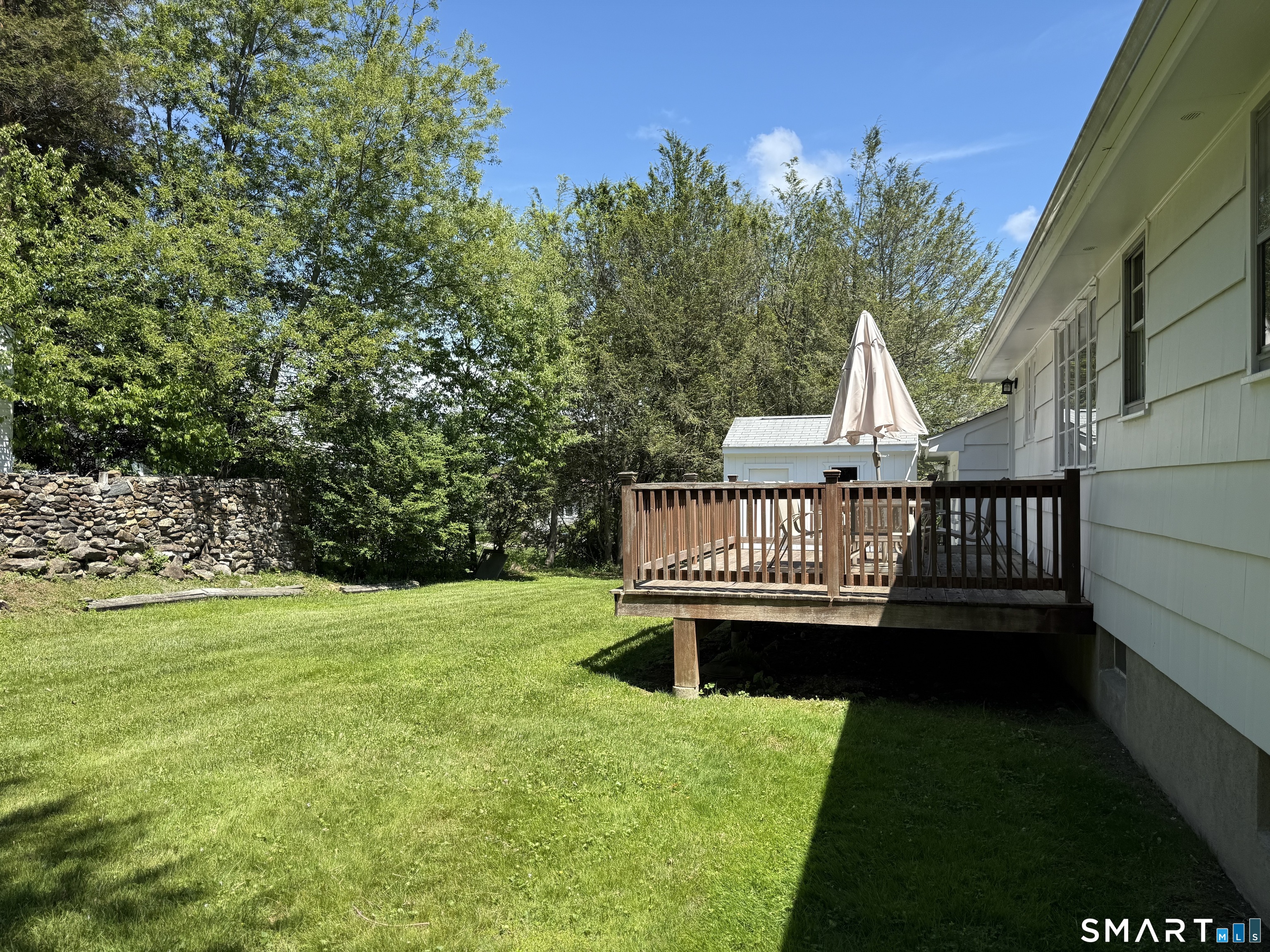 26 Maple Street Trumbull, CT 06611 - Photo 9 of 37 a view of a deck with a chair and iron fence