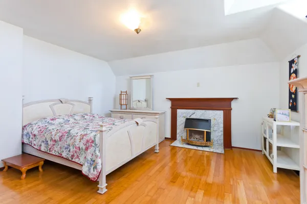 a bedroom with a bed and a fireplace