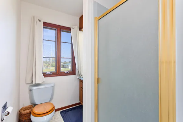 a bathroom with a toilet a sink and a window