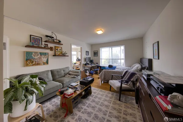 a bedroom with a bed couch and a window