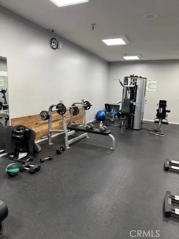 a room with gym equipment and a table