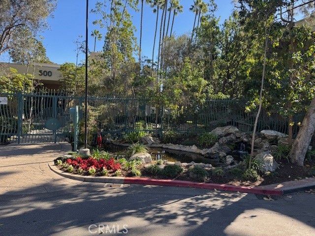 564 North Bellflower Boulevard, Unit 203 Long Beach, CA 90814 - Photo 19 of 20 a view of street with flower plants and large tree