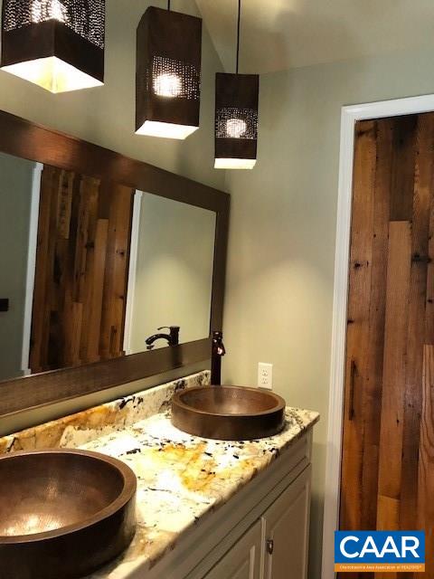 4601 South Blue Ridge Turnpike South Rochelle, VA 22738 - Photo 15 of 20 a bathroom with a granite countertop sink and a mirror