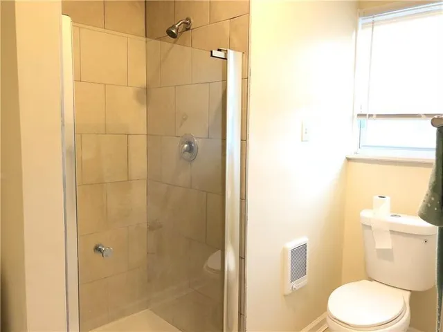 a white toilet sitting next to a bathroom sink