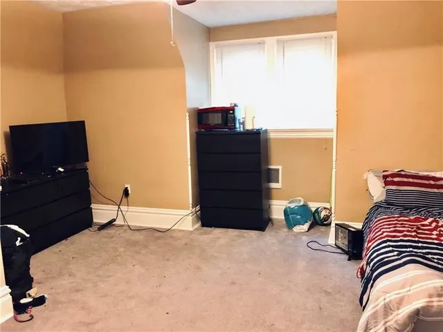 a bedroom with a bed and a television