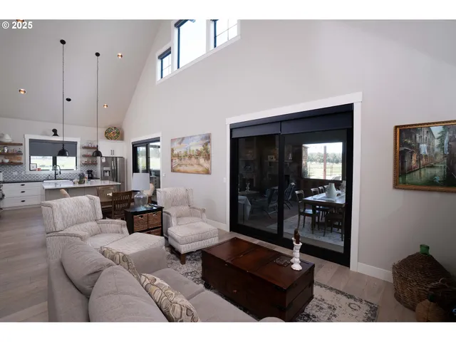 a kitchen with a stove a refrigerator and a dining table with wooden floor