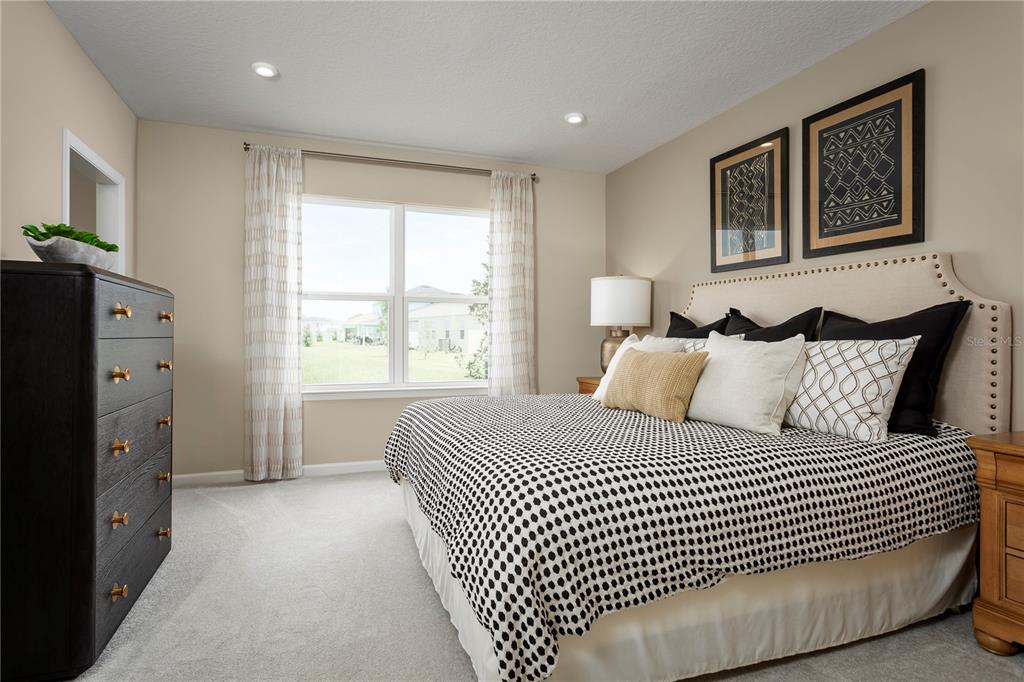 2313 Scenic Pk Loop Wimauma, FL 33598 - Photo 13 of 19 a bedroom with a large bed and a window