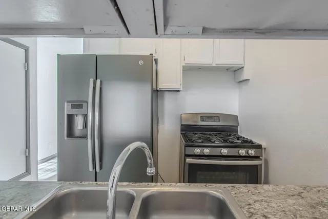 a kitchen with a sink and cabinets
