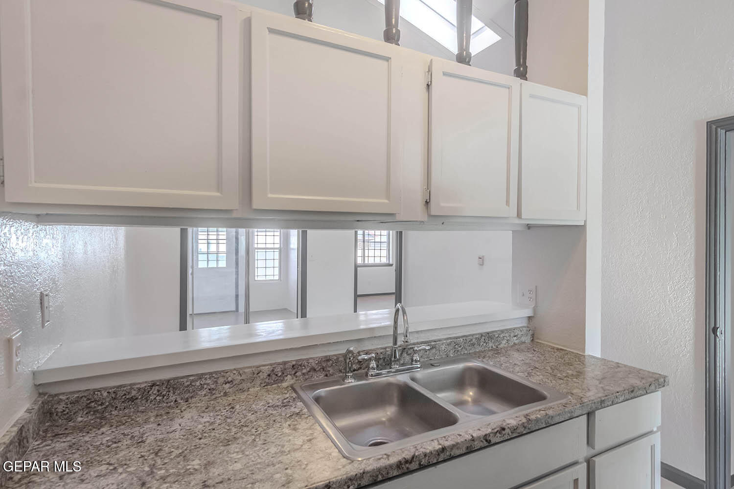 859 Destello Road El Paso, TX 79907 - Photo 12 of 43 a kitchen with a sink and cabinets