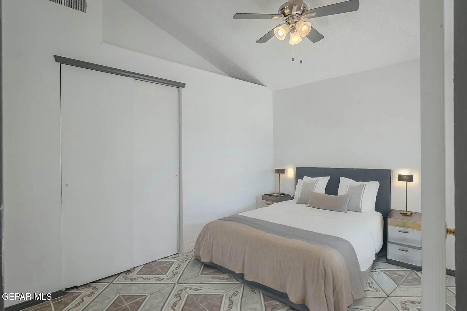 859 Destello Road El Paso, TX 79907 - Photo 27 of 43 a bedroom with a bed and a chandelier