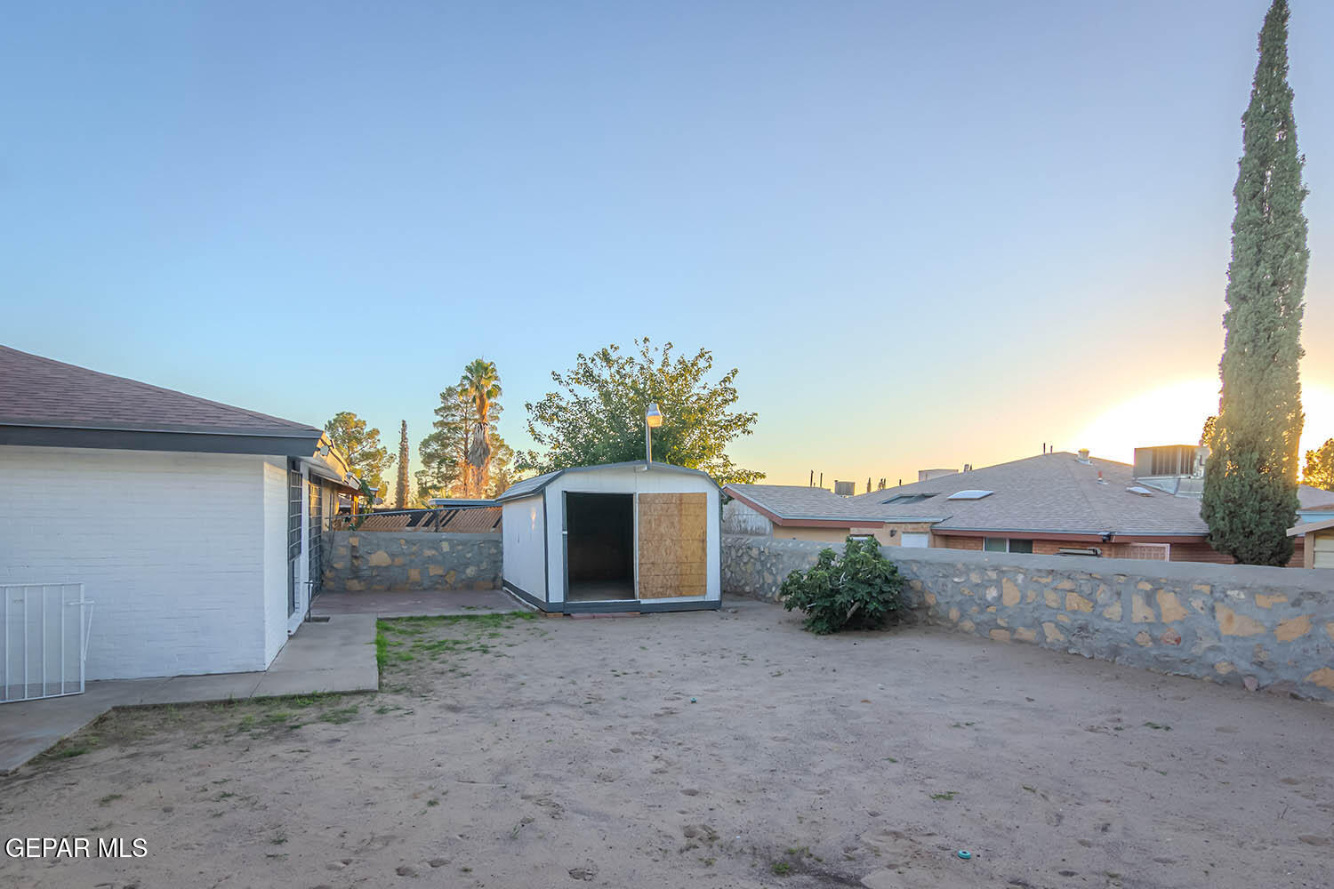 859 Destello Road El Paso, TX 79907 - Photo 41 of 43 a view of a dry yard with a tree
