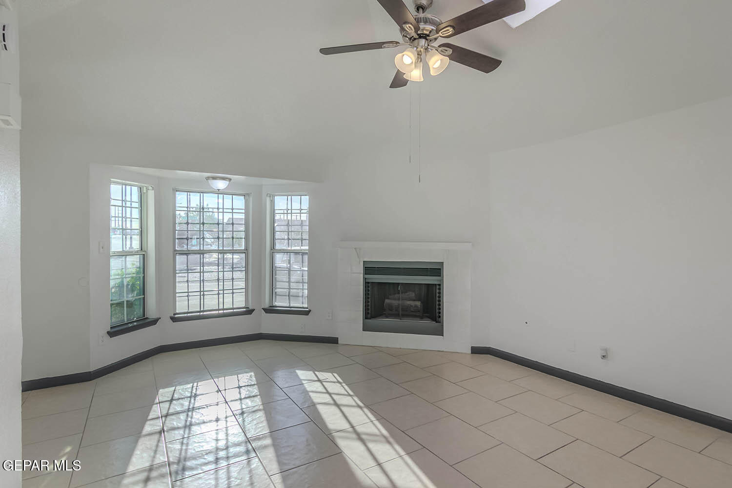 859 Destello Road El Paso, TX 79907 - Photo 6 of 43 a view of an empty room with a fireplace and a window