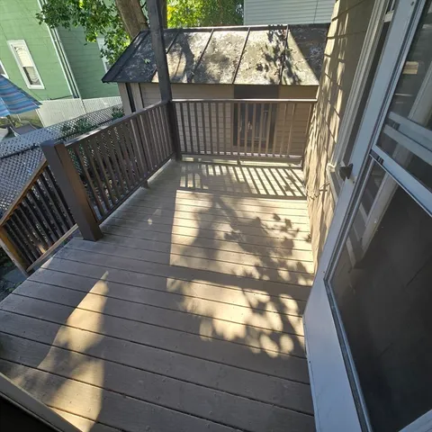 a view of balcony with wooden floor