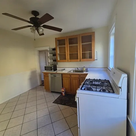 a kitchen with a stove a sink and a refrigerator