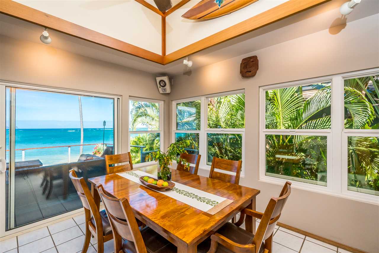 602 Stable Road Paia, HI 96779 - Photo 15 of 30 a view of a dining room with furniture large windows and wooden floor