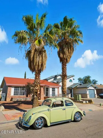 a view of a cars park in front of a building