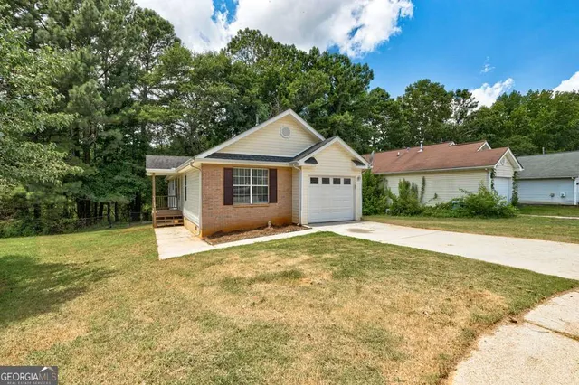 a front view of a house with a yard