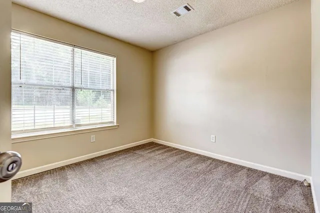 an aerial view of a house with a yard and lake view