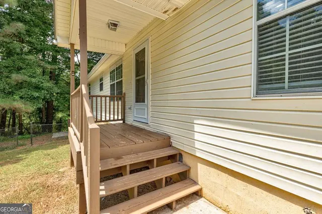 a view of a livingroom with a fireplace a chandelier and closet