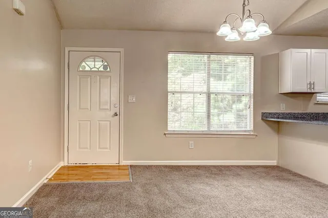 a kitchen with kitchen island granite countertop a stove a sink a center island and cabinets