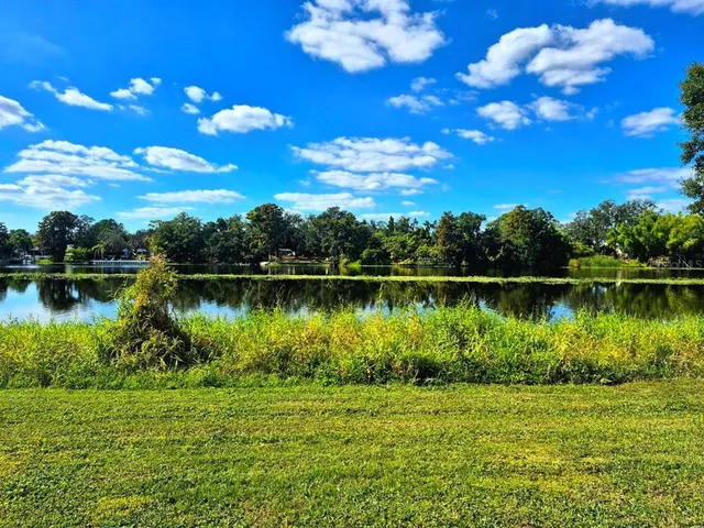 a view of a lake with a big yard