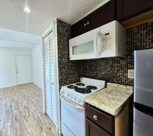 a kitchen with a sink stove and cabinets