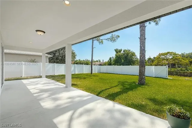 a view of an house with backyard and tree