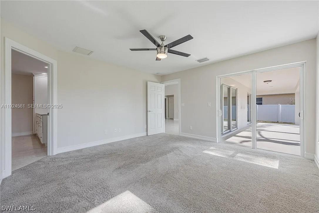 830 Angelo Avenue Lehigh Acres, FL 33971 - Photo 14 of 29 a view of livingroom with hardwood floor and a ceiling fan