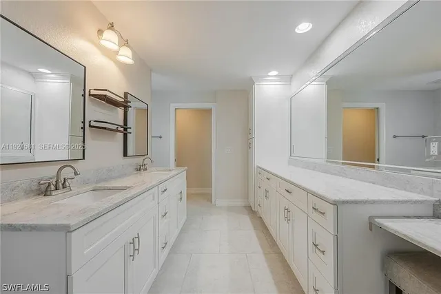a spacious bathroom with a double vanity sink and a mirror
