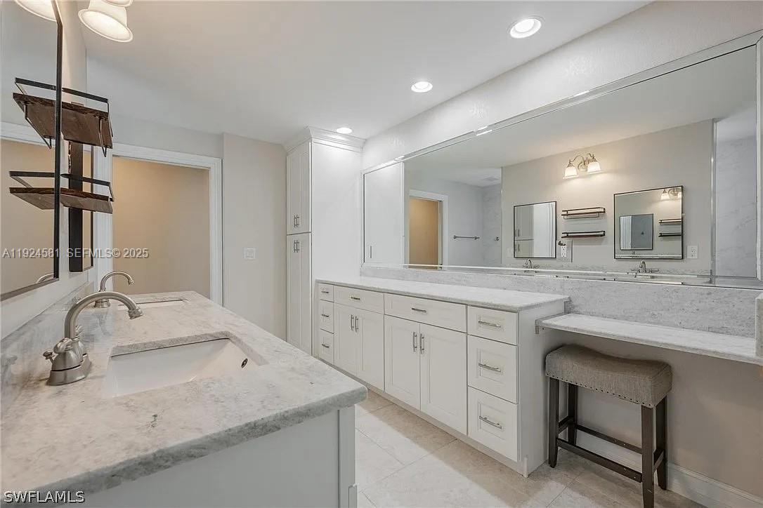 830 Angelo Avenue Lehigh Acres, FL 33971 - Photo 17 of 29 a bathroom with a granite countertop sink double and mirror