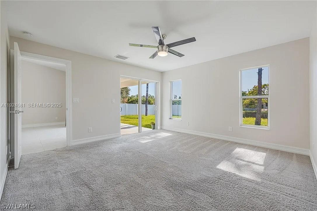 830 Angelo Avenue Lehigh Acres, FL 33971 - Photo 20 of 29 an empty room with window and ceiling fan