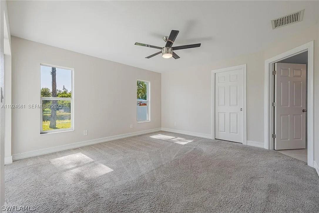 830 Angelo Avenue Lehigh Acres, FL 33971 - Photo 21 of 29 a view of an empty room with a window