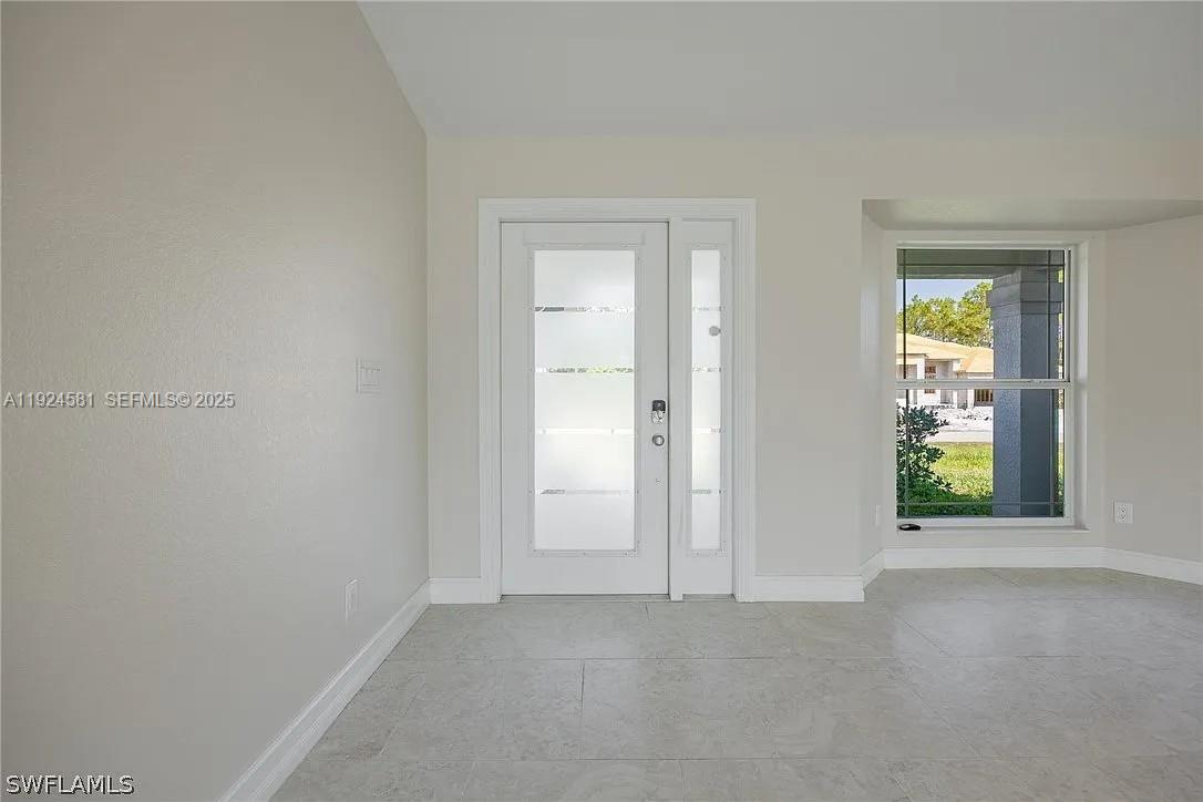 830 Angelo Avenue Lehigh Acres, FL 33971 - Photo 25 of 29 an empty room with windows