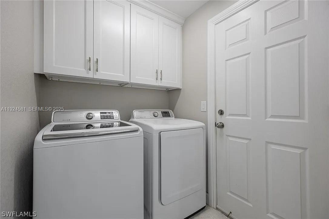 830 Angelo Avenue Lehigh Acres, FL 33971 - Photo 27 of 29 a utility room with dryer and washer