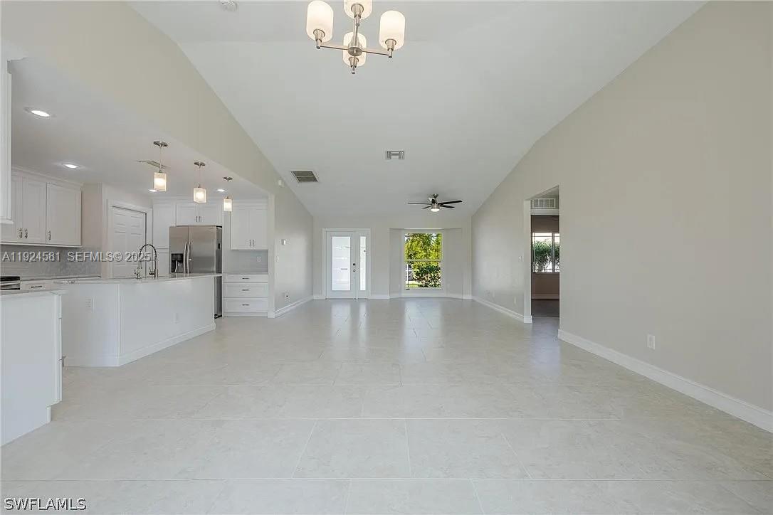 830 Angelo Avenue Lehigh Acres, FL 33971 - Photo 8 of 29 a view of an empty room with kitchen and window