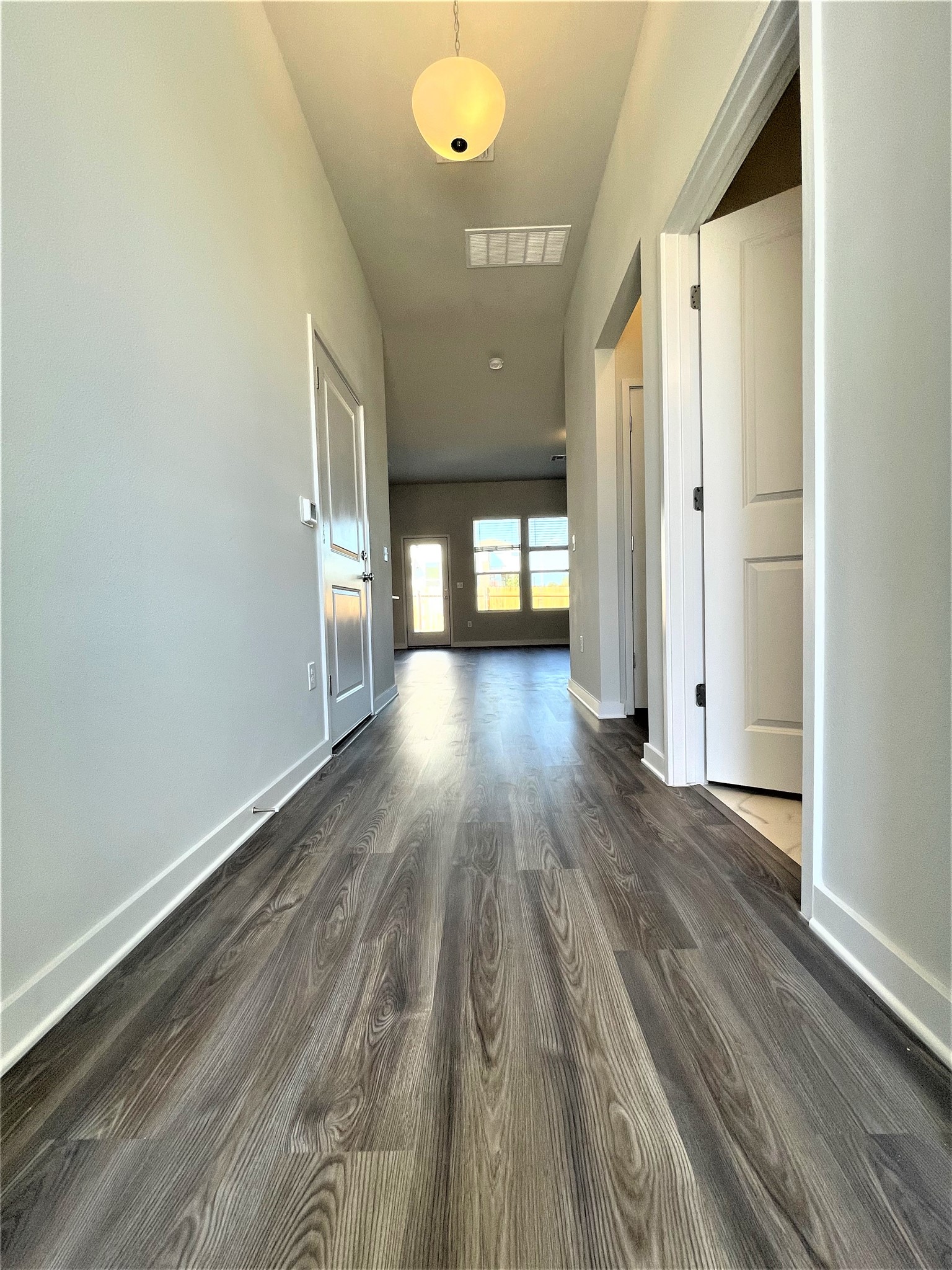 15110 Forum Avenue Pflugerville, TX 78660 - Photo 7 of 29 a view of a hallway with wooden floor