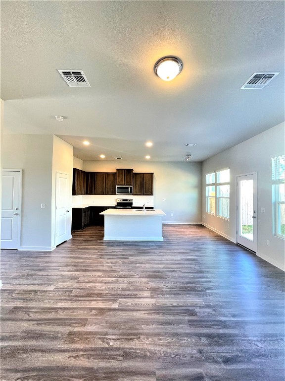 15110 Forum Avenue Pflugerville, TX 78660 - Photo 29 of 29 a view of kitchen with kitchen island microwave and wooden floor